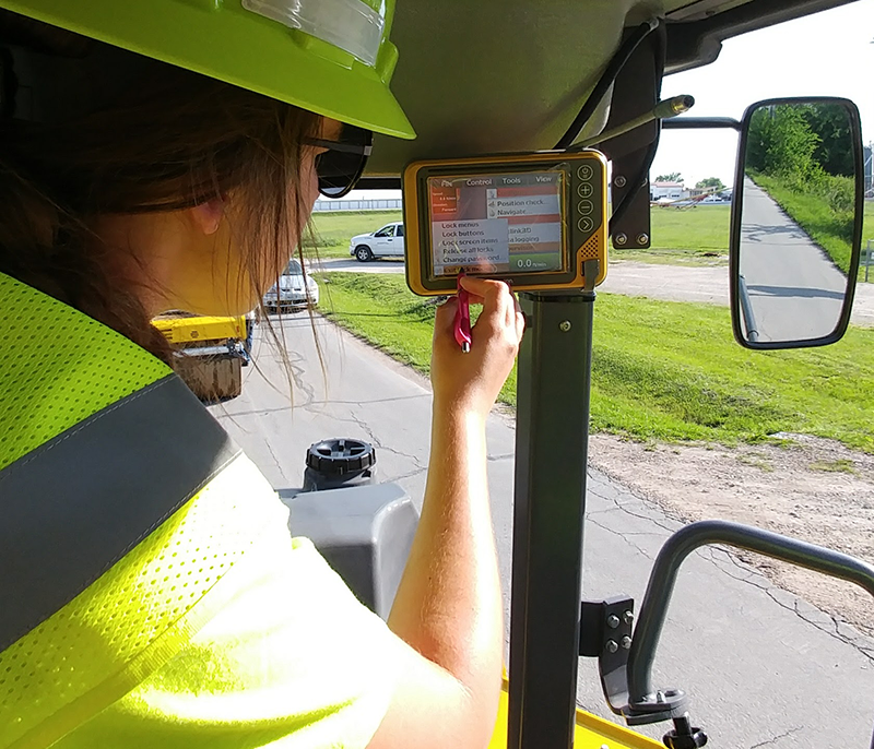 Marli Hayes, Assistant Project Manager at Capital Paving and Construction, sets up the TOPCON IC system.